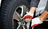Car mechanic changing tire in professional car repair service